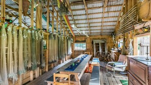 A rustic wooden interior with a long table, benches, and hanging items. - Lilla nennebo by Interhome (Salo)