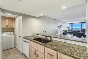 Enjoy ocean views from the adjacent living area, where a kitchen with a sink and washer/dryer awaits.