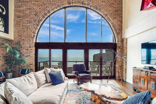 2 Story Penthouse with Floor to Ceiling Arched Window & Stunning View of the Ocean