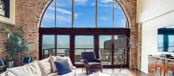 2 Story Penthouse with Floor to Ceiling Arched Window & Stunning View of the Ocean
