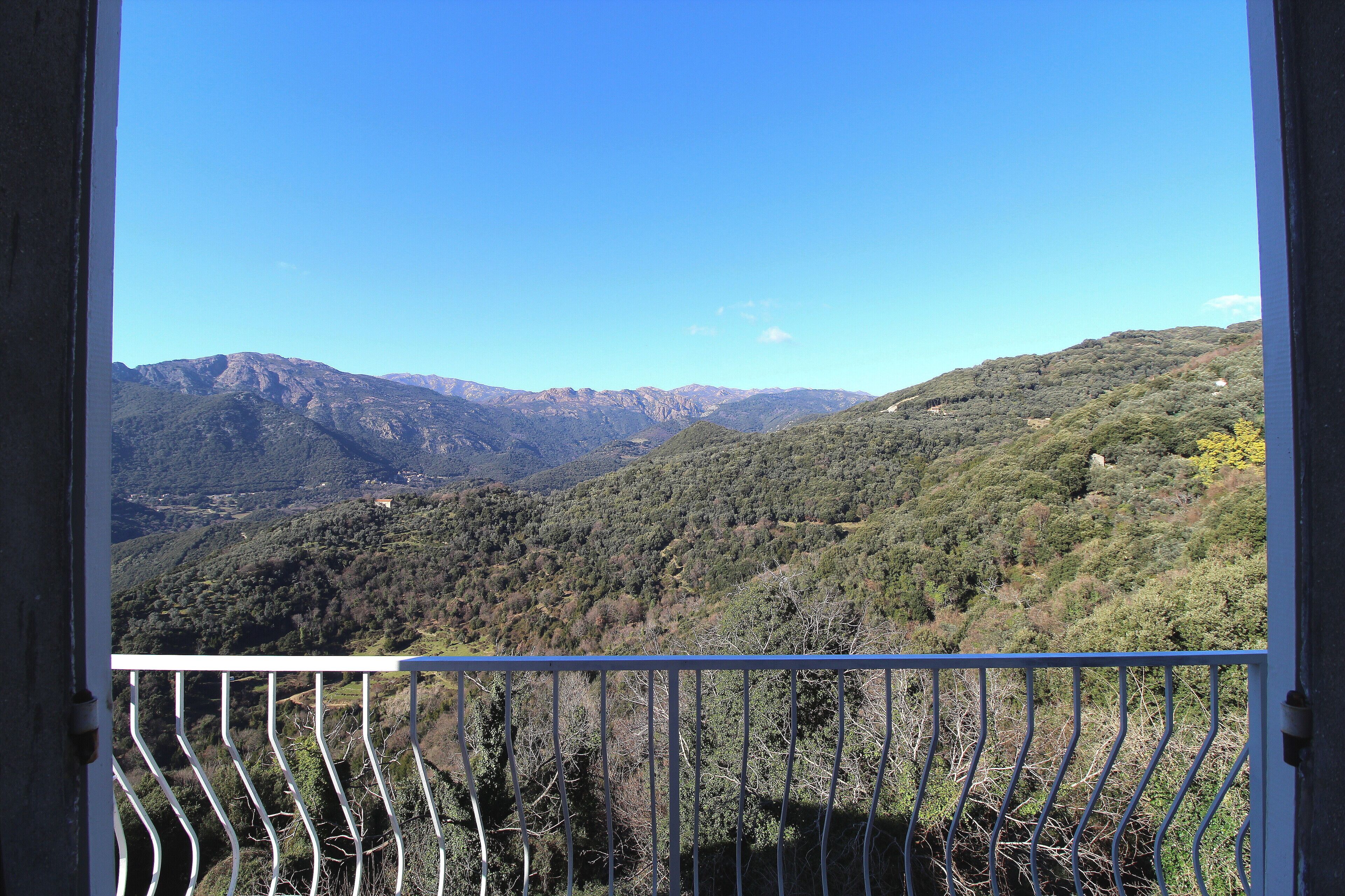Un balcón con vistas a un paisaje montañoso.