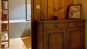A wooden interior with a wall-mounted photo collage and a wooden cabinet.