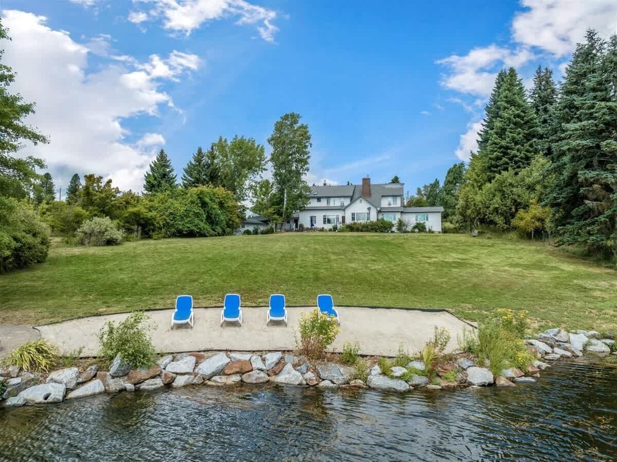 A house with a swimming pool and lounge chairs.