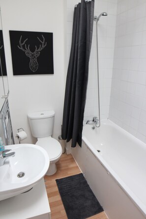Classic Apartment | Bathroom | Spring water bathtub, hair dryer, towels, soap
