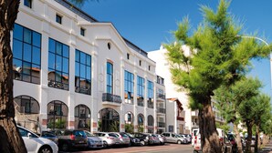 A multi-story building with large windows and a white facade.