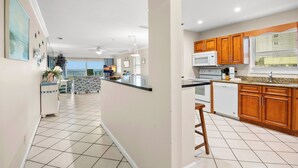 A spacious kitchen with wooden cabinets, a microwave, and a dishwasher.