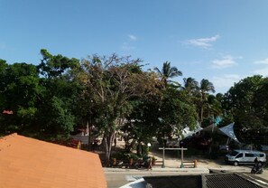 Stroll along the paved walkway and enjoy the serene surroundings, complete with lush trees and a seating area.