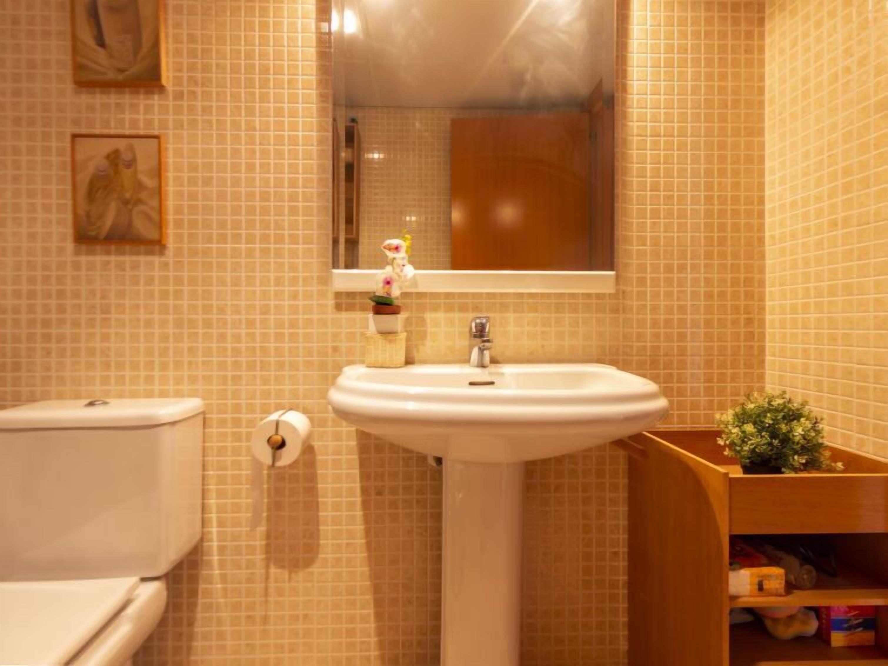Ein Badezimmer mit Toilette, Waschbecken und Spiegel.