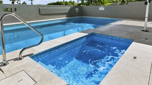 A swimming pool with a tiled edge and a metal ladder. - Exquisite Penthouse with views to Laguna Bay - Unit 3 Taralla 18 Edgar Bennett Avenue (Noosa Heads)
