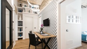 A modern dining area with a wooden table, black chairs, and a patterned wall. - Charming Trastevere home overlooking a medieval church: suite, 3 baths, WiFi, AC (Roma)