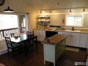 Enjoy cooking in this well-equipped kitchen with a central island, dining table, and sink.
