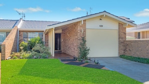 A residential house with a garage, brick exterior, and a well-maintained lawn. - 29A Ballina Crescent, Port Macquarie (Port Macquarie)