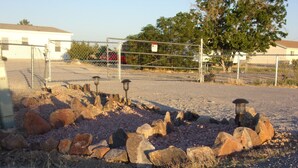 A gravel area with rocks and two lantern-style lights. - $89/night for 2 people, plus $20/night for each additional person (Pahrump)