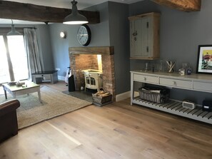 Cozy living room with a comfortable sofa, vintage radio, and fireplace.