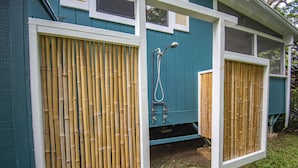 A blue house with a bamboo screen door and a shower. - Sleeping Giant Cottage with Plunge Pool TNVC #1244 (Kapaa)