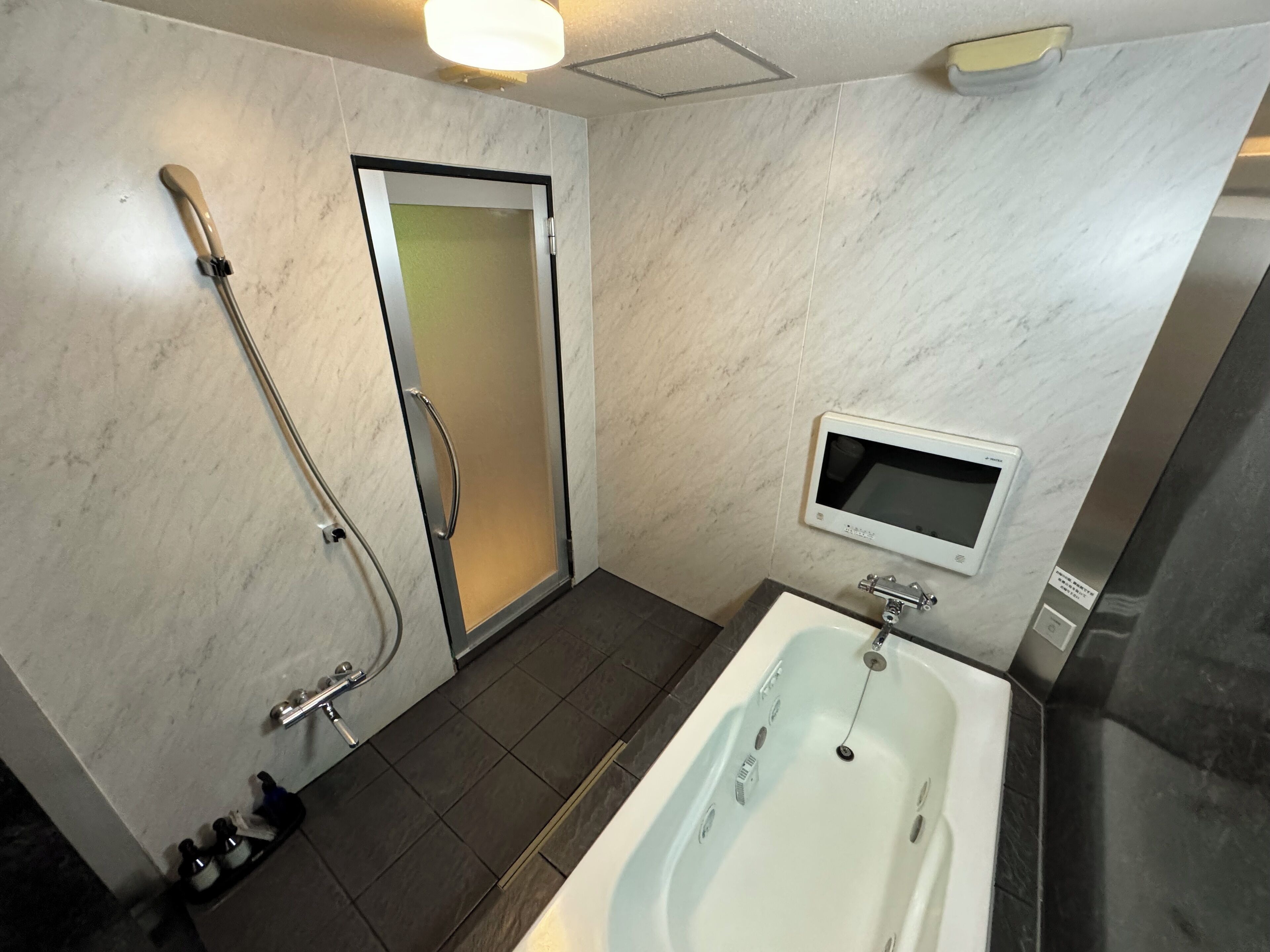 A modern bathroom with a bathtub, a shower, a toilet, and a sink.