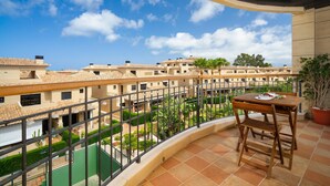 A balcony with a view of a residential area, a table with chairs, and a potted plant. - Beautiful and cheerful holiday house in Javea, Costa Blanca, Spain  with communal pool for 2 persons (Javea)