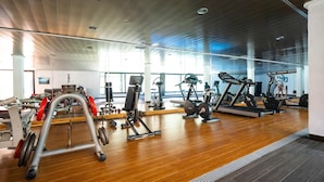 A gym with various exercise equipment, wooden flooring, and large windows allowing natural light. - Beautiful and cheerful holiday house in Javea, Costa Blanca, Spain  with communal pool for 2 persons (Javea)