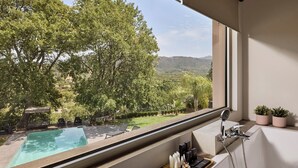 A balcony with a view of a swimming pool, a shower area, and potted plants. - BBQ & Jacuzzi★HEATED pool★Big Garden★2 cars rental included★18 sleeps (Alikianos)