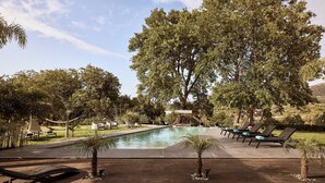 A pool area with lounge chairs and a wooden deck. - BBQ & Jacuzzi★HEATED pool★Big Garden★2 cars rental included★18 sleeps (Alikianos)