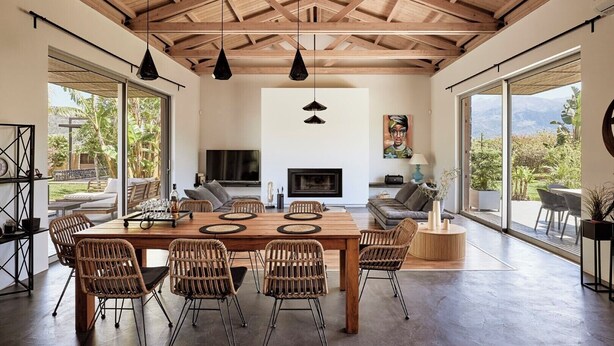 A spacious living area with a wooden ceiling, large windows, and a fireplace. - BBQ & Jacuzzi★HEATED pool★Big Garden★2 cars rental included★18 sleeps (Alikianos)