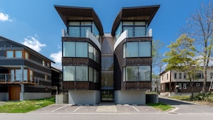 A modern building with a symmetrical design, featuring large windows and a central entrance.