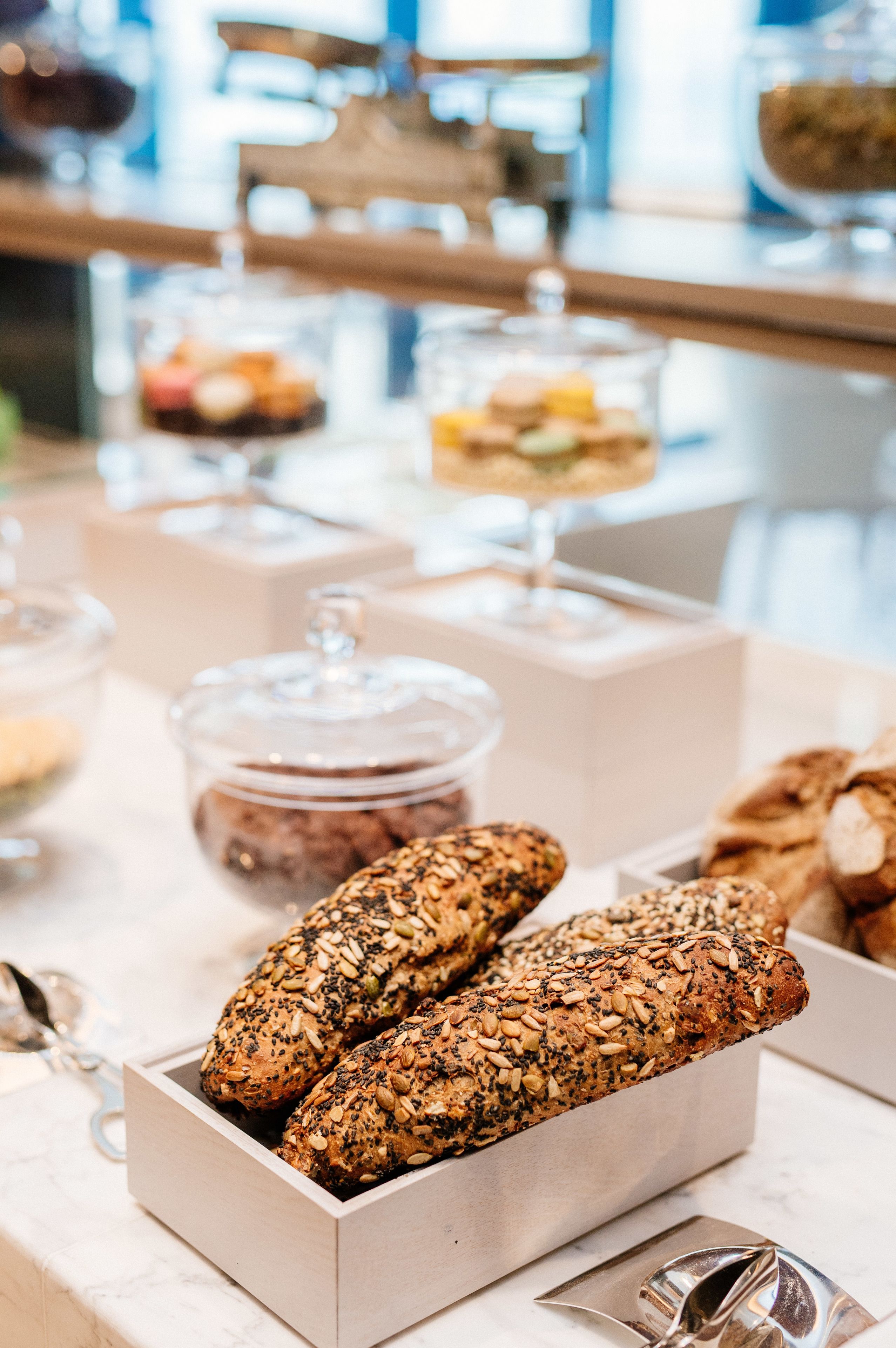 A bakery display with various baked goods and containers.