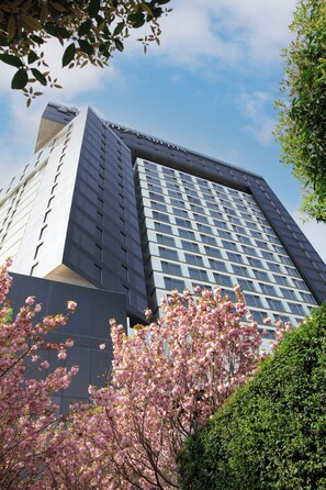 A modern building with a grid of windows and a prominent entrance.