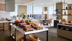A modern kitchen with a city view, featuring a breakfast buffet with various pastries and fruits. - The Ritz-Carlton, Xi'an (Xi'an)