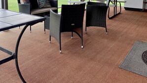 An outdoor patio area with a table and chairs, a refrigerator, and a view of a grassy field. - Views, Central AC, Location and Solitude (Irwin)