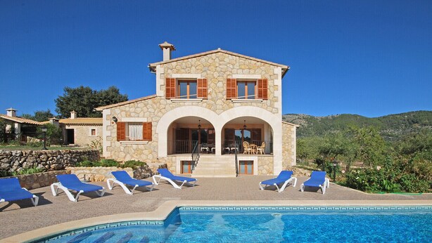 A stone villa with a pool, outdoor seating, and a view of the hills. - Ses Rotes - Spacious country house with private pool for 10 people in Mallorca (Campanet)