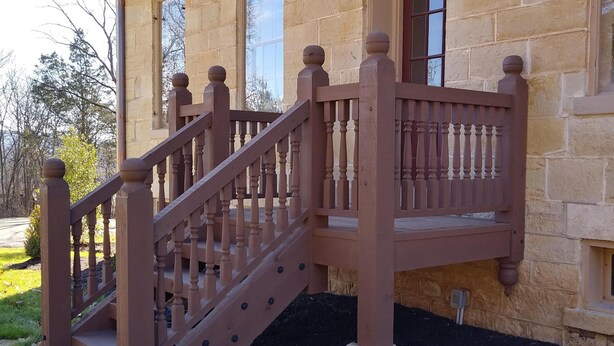A wooden staircase leading to a balcony with stone walls and a window. - Funks Inn, a post civil war era home restored as it was in 1870. (Bloomsdale)