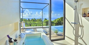 A modern bathroom with a large window, a bathtub, and a shower. - Kounosu (Nakijin)