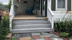 A house with a porch, an American flag, and a number '12' on the window. - Only 2 Minutes Walk to Boardwalk, Beach, Eats & Fun! Large Well-Appointed Home. (Weirs Beach, Laconia)