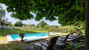 A swimming pool with lounge chairs and a white picket fence in the background. - Luxury Suite in Renaissance Villa (Grassina)