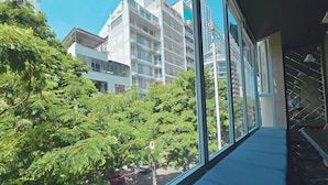 A view from a window overlooking a street with trees and buildings. - Hermes Hotel Nha Trang (Nha Trang)