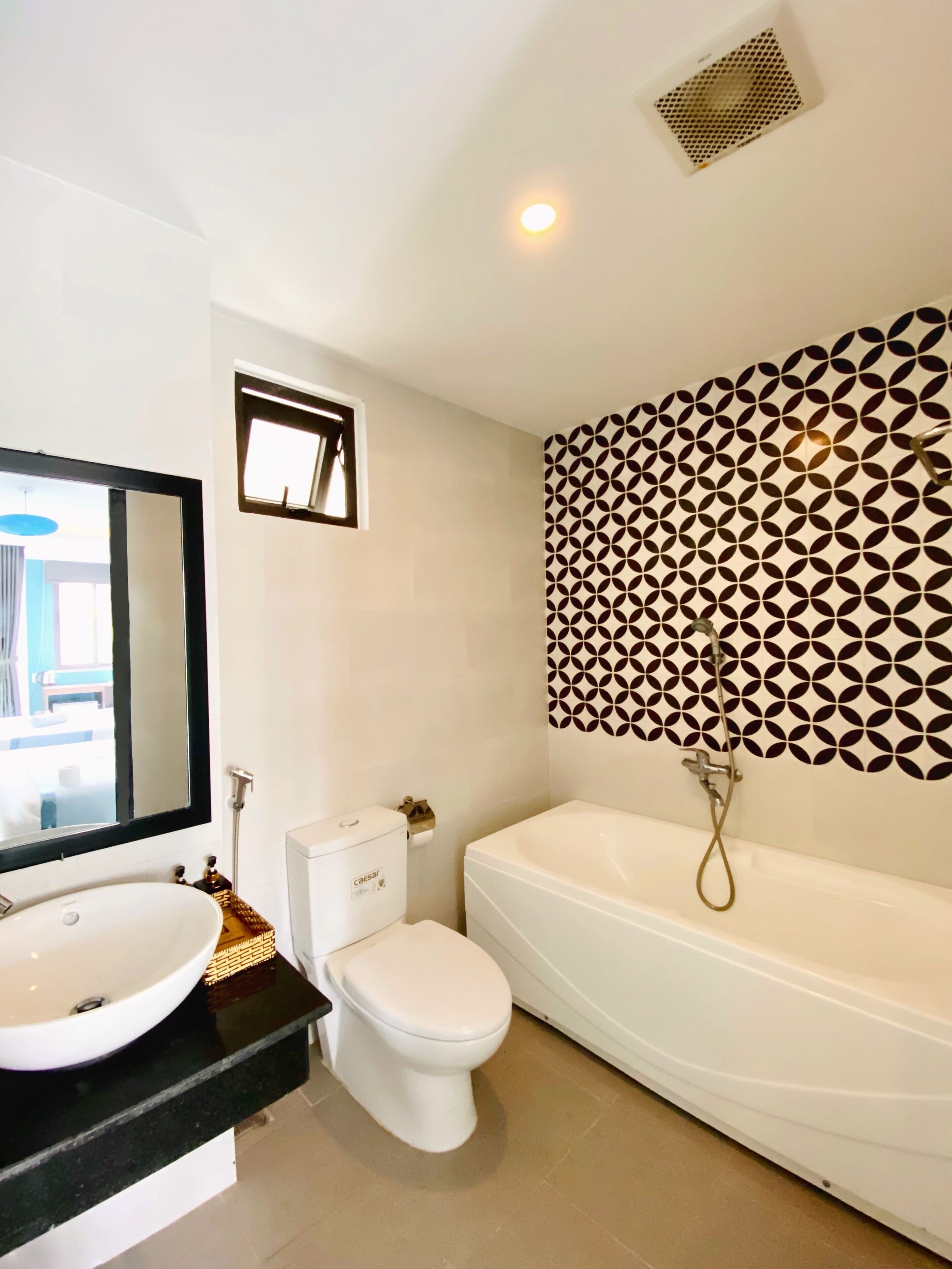 A bathroom with a sink, toilet, and bathtub.