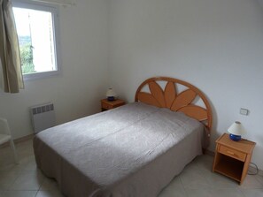 Cozy retreat with a single bed, bedside tables, and a radiator.