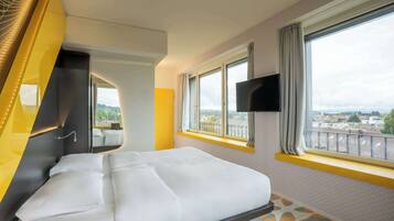 Premium bedding, desk, laptop workspace, blackout drapes