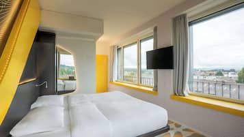 Premium bedding, desk, laptop workspace, blackout drapes