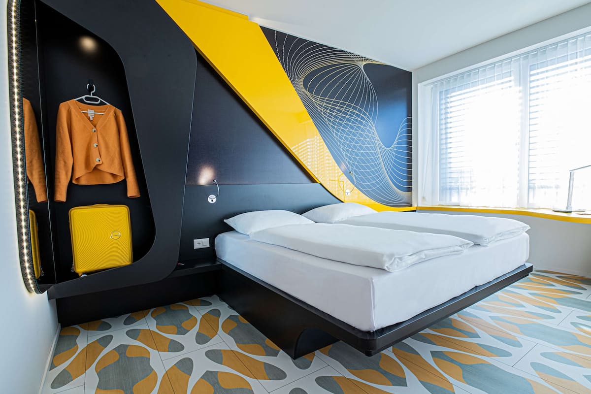 Premium bedding, desk, laptop workspace, blackout drapes