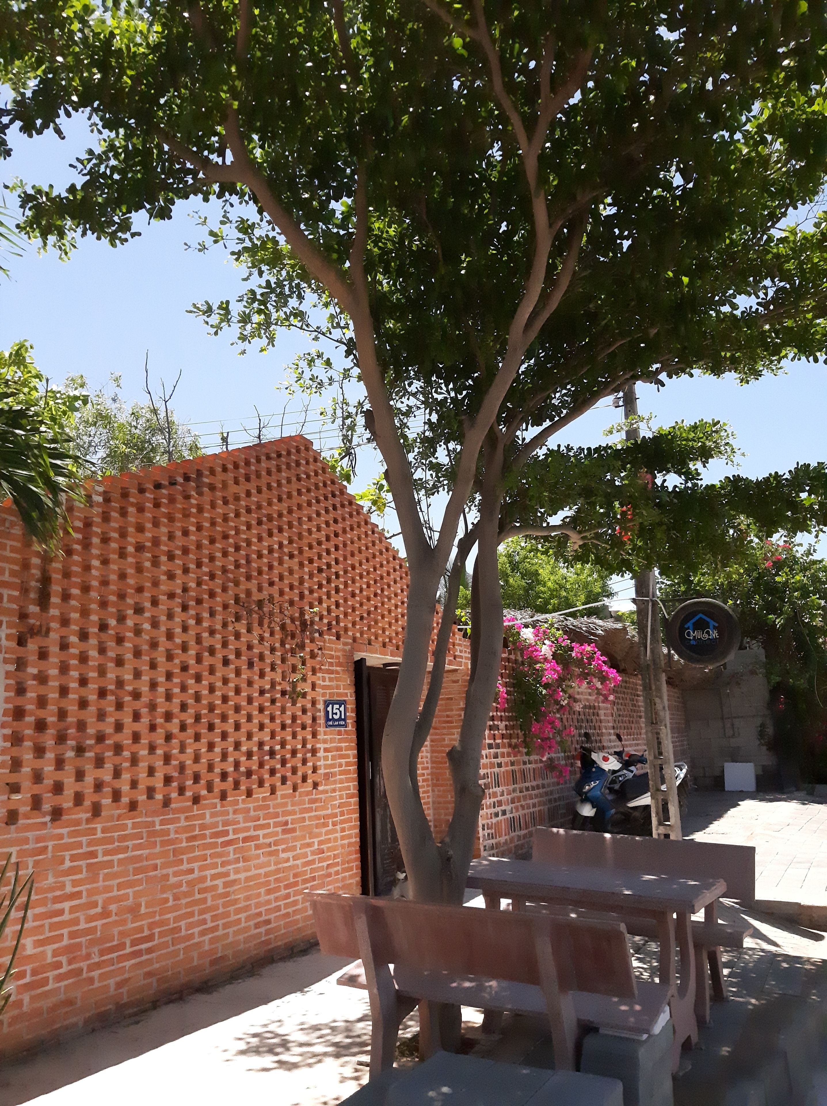 A brick building with a sign indicating a public space.