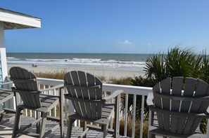 A deck with three Adirondack chairs overlooking a beach. - My Blue Heaven - Oceanfront in Surfside Beach (Surfside Beach)