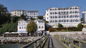 A waterfront building with multiple balconies and a sign reading "FÜRSTENHOF".