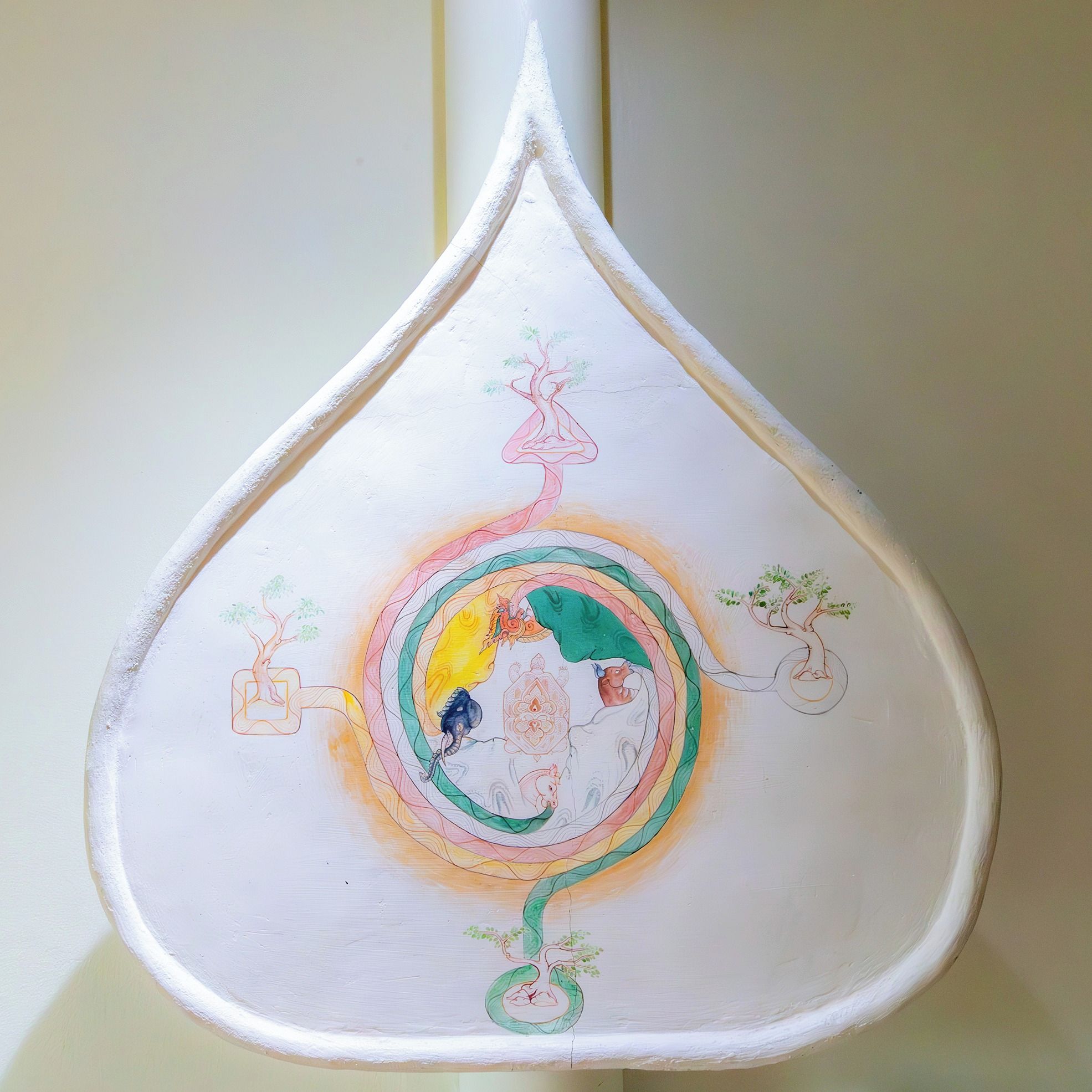 A white teapot with a unique teacup design.