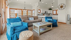 A spacious living area with a sofa, two armchairs, a coffee table, and a kitchen in the background. - Sea-U-Later!: 820 Ft to Beach Access; Private Pool, Hot Tub (Duck)