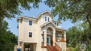 A two-story house with a front porch, a staircase, and a garage door. - Sea-U-Later!: 820 Ft to Beach Access; Private Pool, Hot Tub (Duck)