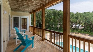 A wooden deck with a pool, chairs, and a view of trees. - Sea-U-Later!: 820 Ft to Beach Access; Private Pool, Hot Tub (Duck)