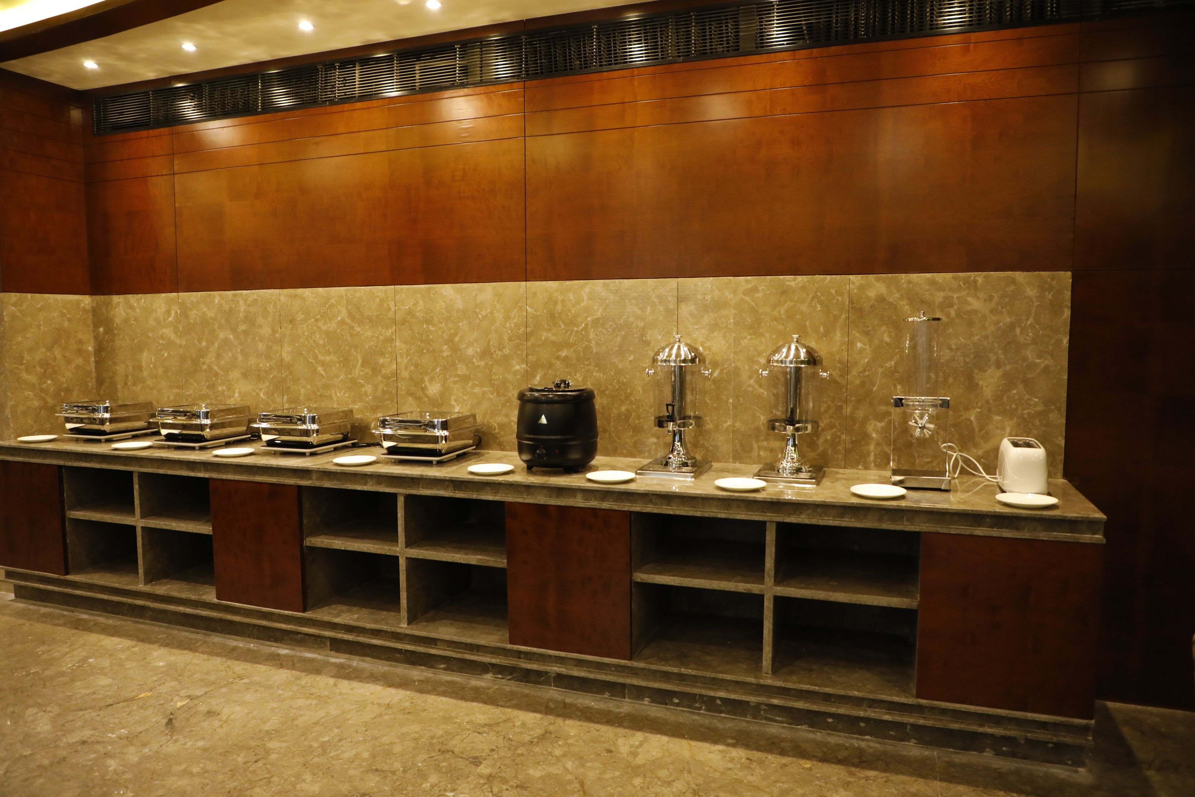 A buffet setup with various food items and appliances.