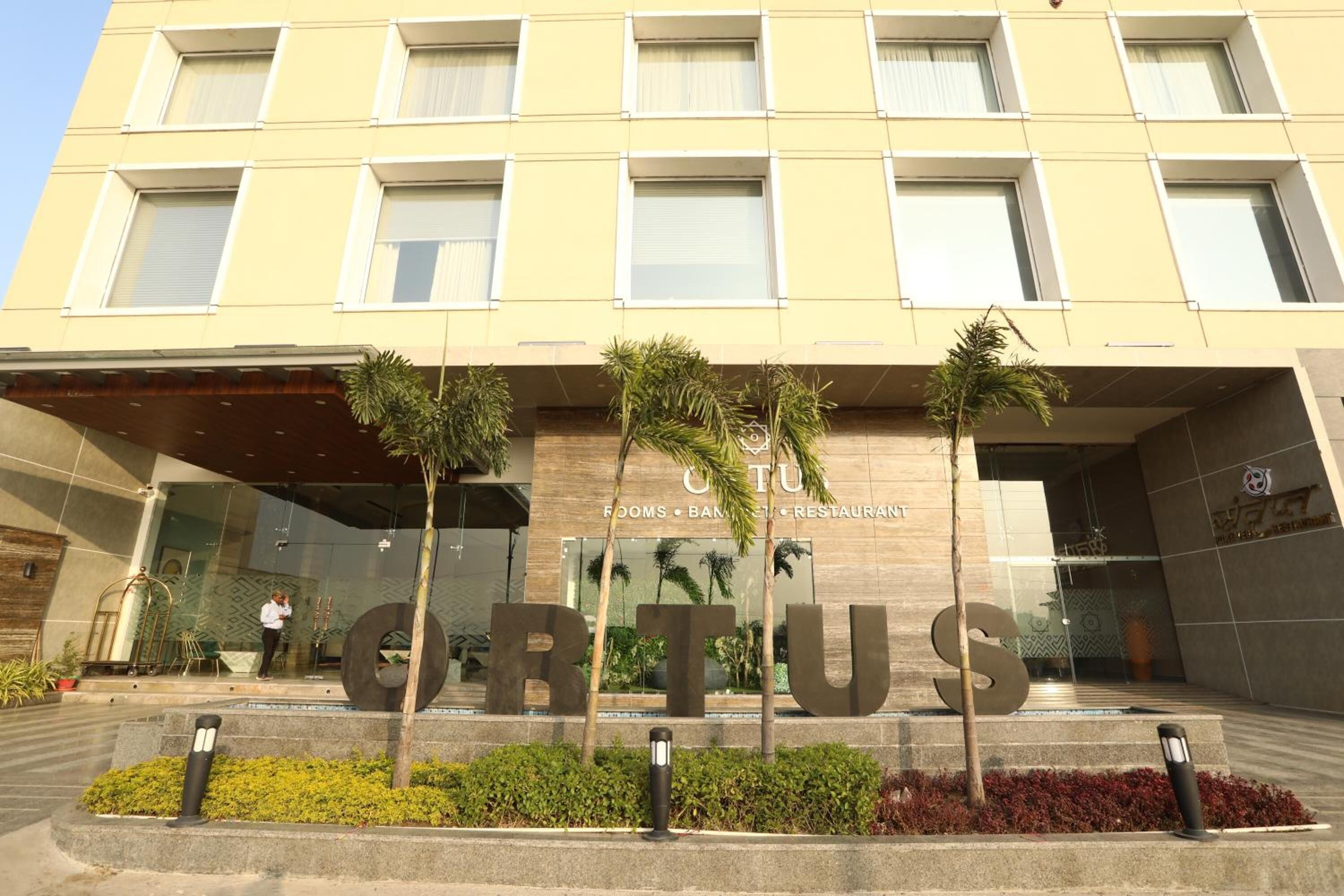 A modern building with a sign reading "ORTUS" and a large 'S' in the entrance.